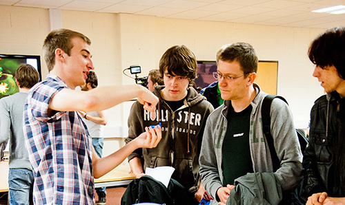 Three prospective students observing an open day demonstration